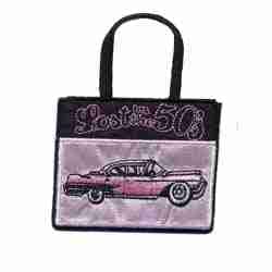 A Lost in the 50's Shopping Bag Iron on Patch with a pink car on it.