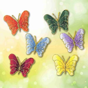 A set of Small Decorative Butterfly Iron On Patches: Multiple Colors on a green background.