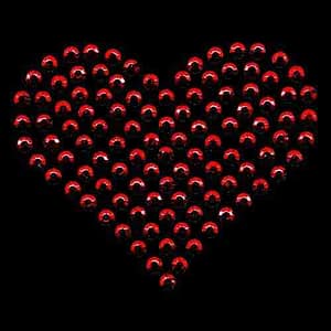 A Rhinestud Heart Iron On Hotfix Applique: Large - Red made of red beads on a black background.