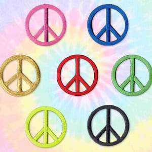 Six different colored Peace Sign Patches (5 Pack) Symbol Embroidered Iron On Patch Appliques on a tie dye background.