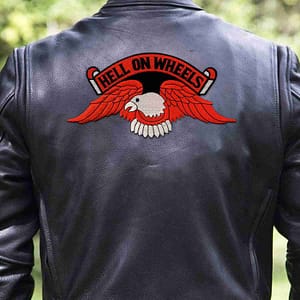 A man wearing a Hell on Wheels Orange Eagle Back Patch Iron On Patches on his leather jacket.