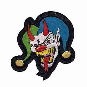 A Blue and Green Evil Jester iron on patch on a white background.