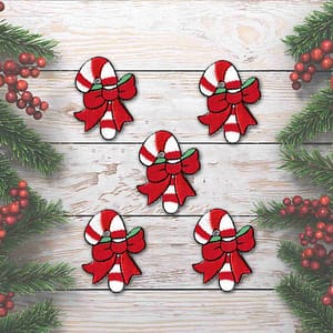 Four Candy Cane Patches (5-Pack) Christmas Embroidered Iron On Patch Applique with bows on a wooden background.