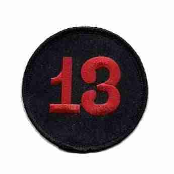 A black and red Number 13 Back Patch On Embroidered Iron or Patch- 7 1/2 inch Round with the number 13 on it.