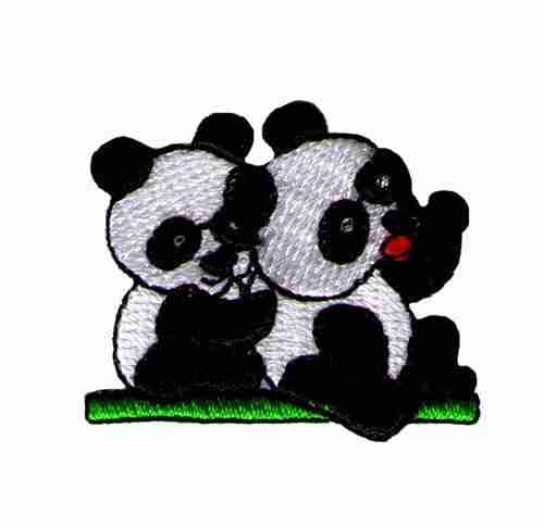 Three Panda Bear Patches (3-Pack) Animal Embroidered Iron On Patch Appliques are sitting on the grass.