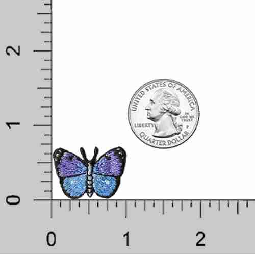 A blue and purple Tiny Butterfly Iron on Patches: Multiple Colors on a ruler next to a dime.