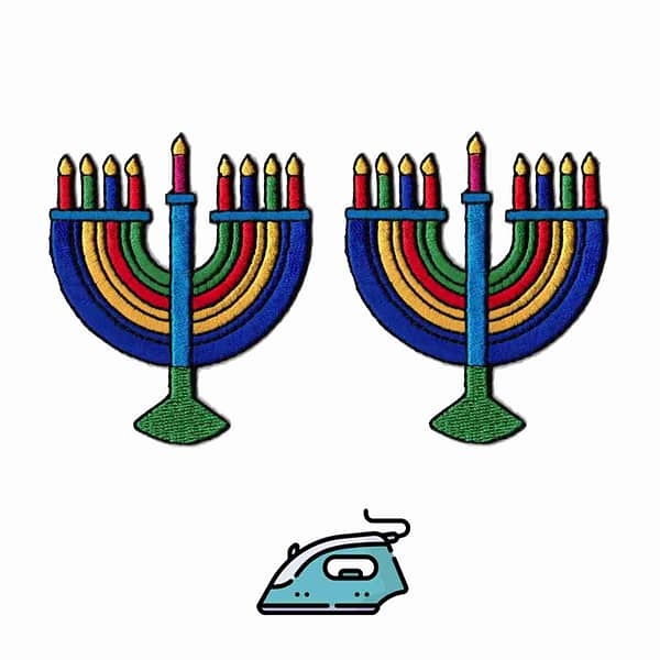 Two Hanukkah - Menorah Candelabra Iron On Patches (2 Pack) on an ironing board.