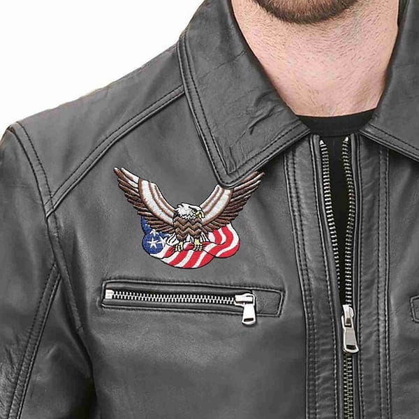 A man wearing a black leather jacket with a Bald Eagle with American Flag Iron On Patch on it.