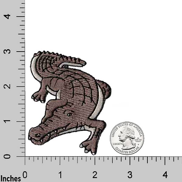 Crocodile Patches (2-Pack) Reptile Embroidered Iron On Patch Appliques embroidered on a ruler.
