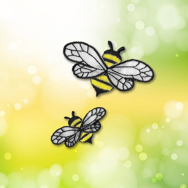 Two Bee Patches with Chiffon Wings (5 Pack) Insect Embroidered Iron on Patch Appliques on a green background.