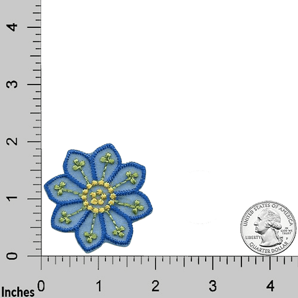 A Large Blue Chiffon Daisy Patches (5-Pack) Floral Embroidered Iron On Patch Appliques embroidered on a ruler.