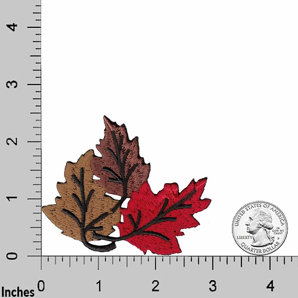 A ruler with two Fall Leaves Patches (2-Pack) Leaves Embroidered Iron On Patch Appliques on it.