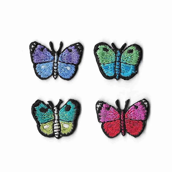 Four Tiny Butterfly Iron on Patches in multiple colors on a white background.