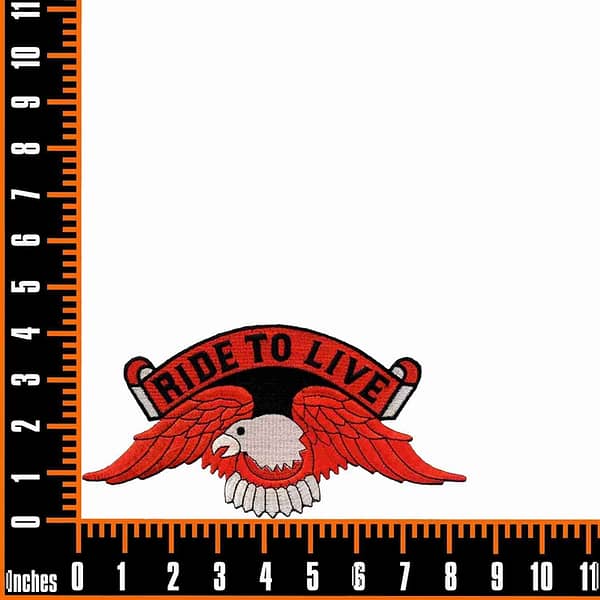 The Ride to Live Orange Eagle Backpatch Iron On Patch is shown on a ruler.