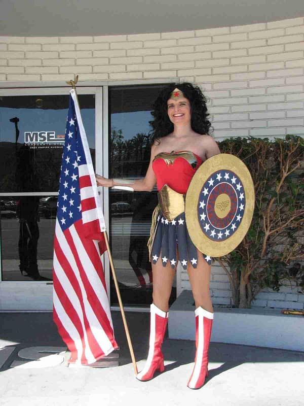 A woman in a 3 Inch Iron on Star Patches (5 Pack) costume standing in front of a building.