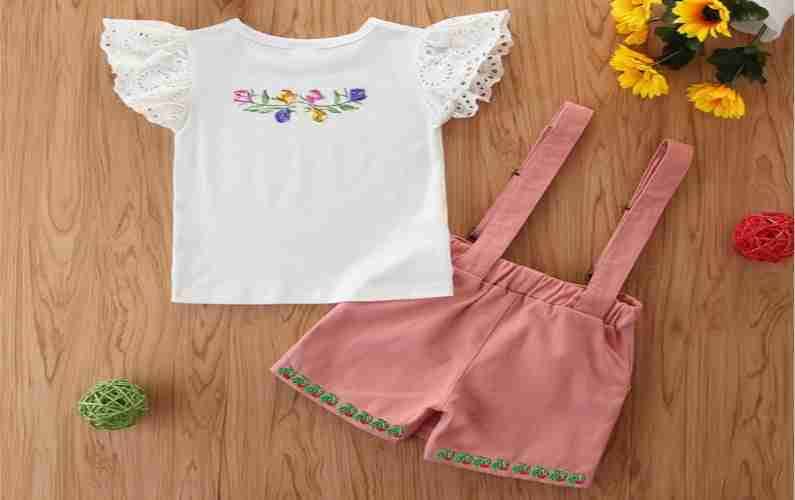 A baby girl's t - shirt and shorts set.