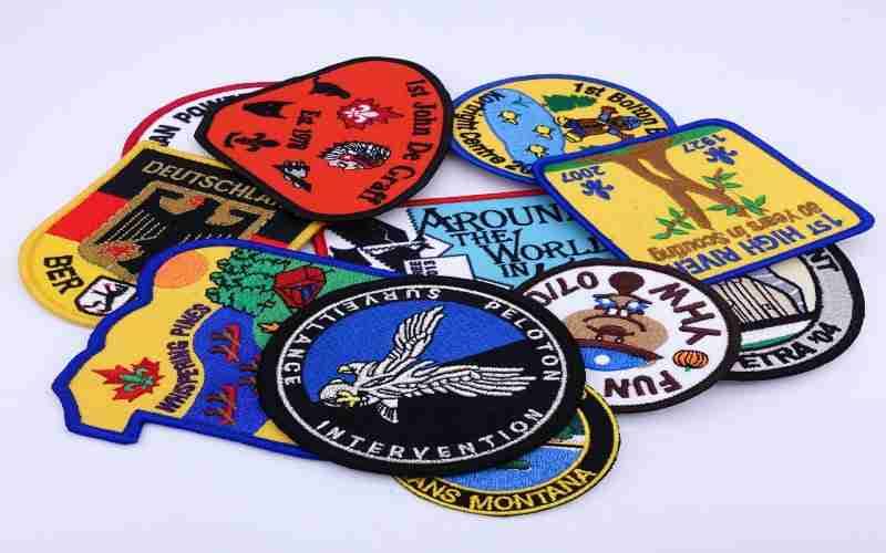 Various embroidered patches on a white surface.