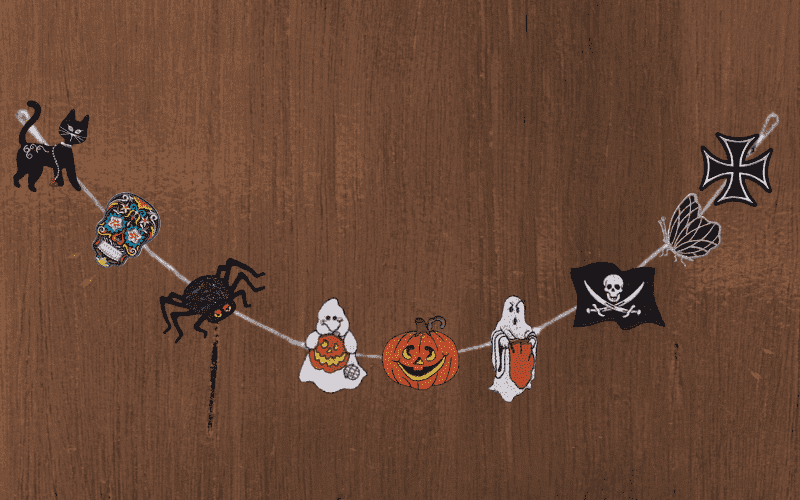 A halloween garland with a black cat, bats, ghosts, and skeletons.