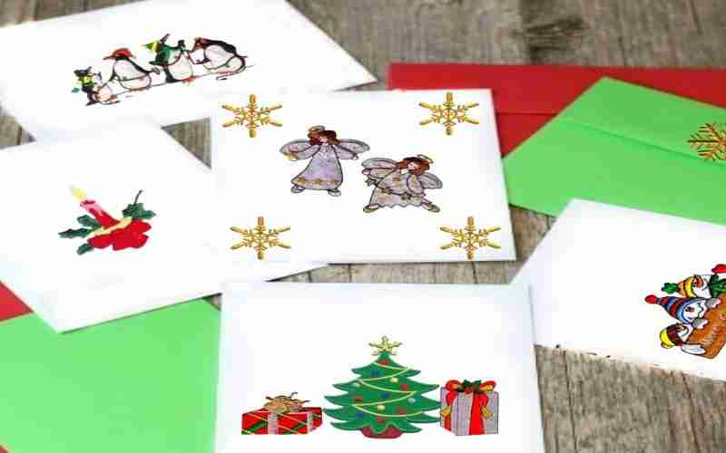 A set of christmas cards with a christmas tree, reindeer, and santa claus.