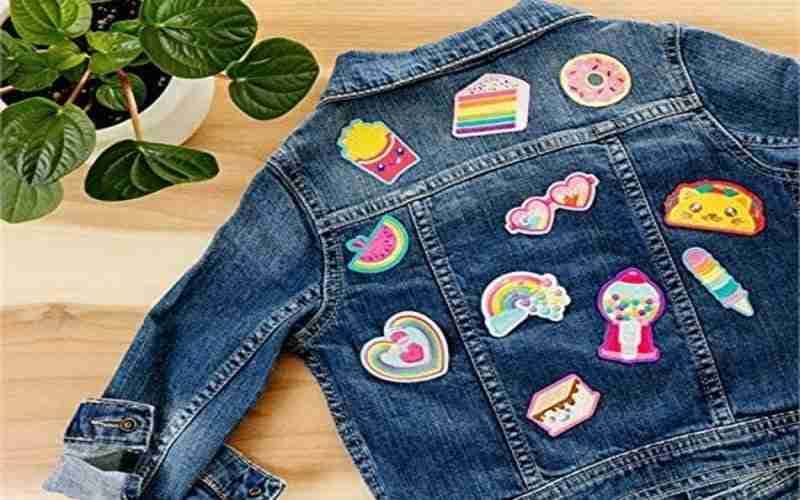 A denim jacket with embroidered patches on it.