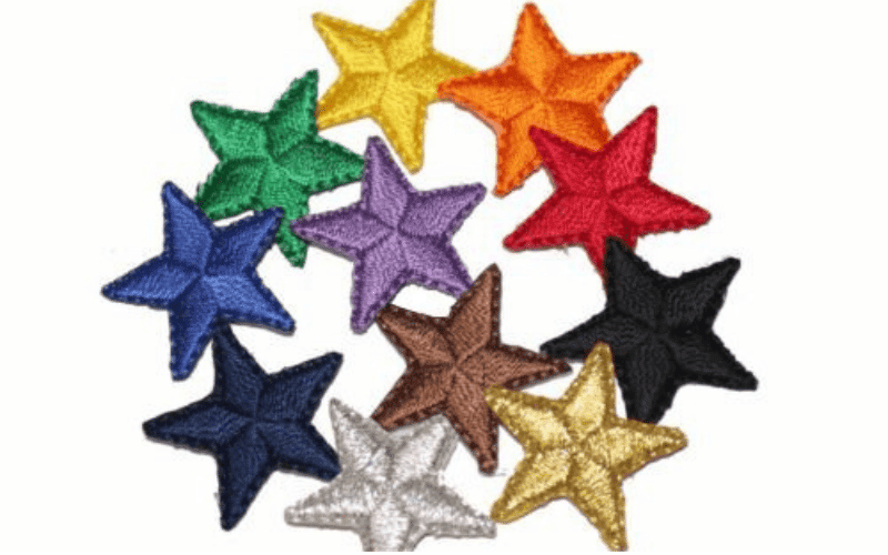 A group of colored star embroidered appliques.